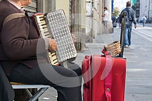 Close Up of Old Beggar Woman Playng a Dirty Accordion in the Street