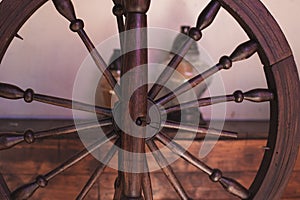 Close up of an old brown spinning wheel