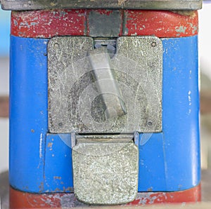 Close-up old candy machine, RUSTY METAL and blue and red painted