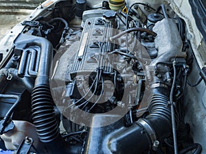 Close up old car engine full of oil stains