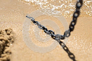 Close up of an chain on a beach