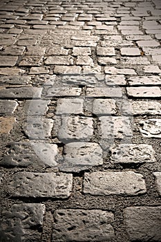 Close up of old cobble stone road surface background texture