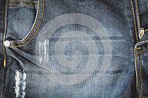 close up of old denim blue jean trousers texture with pocket background