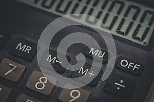 Close-up of an old dusty calculator. Electronic equipment for counting and calculations. Selective focus