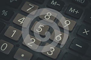 Close-up of an old dusty calculator. Electronic equipment for counting and calculations. Selective focus