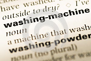 Close up of old English dictionary page with word washing machine