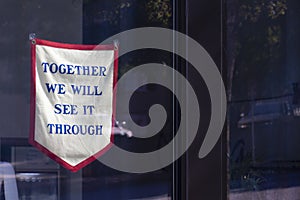 Close-up of an old-fashioned cloth banner hanging in the window of a retail store in Athens, Georgia