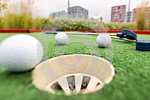 Close up, Old golf balls and putter on artificial grass for practice.