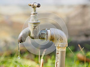 Close up old and grunge faucet and water drop