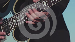 Close-up of old hands of guitarist playing bass guitar. Stock. Masterful performance of playing guitar of old musician