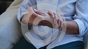 Close up of old hands senior woman massaging from joint pain and feeling hurt. Older grandmother having rheumatoid