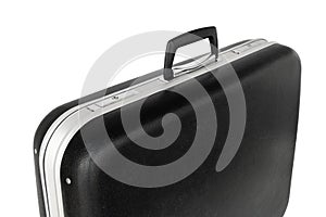 Close up of old hard black suitcase with handle