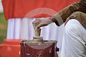 Close up old indian man hand makes pottery items from clay, old potter creates clay vases