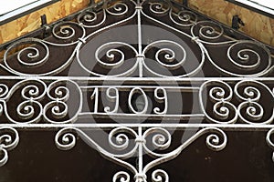 Close-up of an old iron design with inscription 1909 year