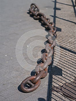 Old iron dock chain still in situ at Canada Water, London, UK.