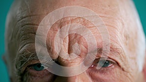 Close-up of an old man combing his bushy eyebrows