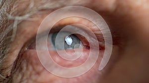 Close-up of old man eye looking alone, wrinkled face and eyes