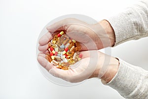 Close up of old man hands holding medicine