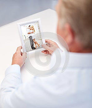 Close up of old man holding young couple photo