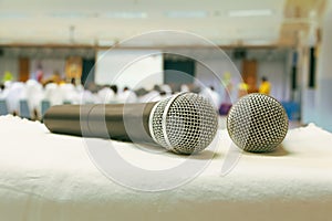 Close up old microphone wireless two on the white table in business conference interior seminar meeting room