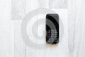 Close-up of old mobile phone on wooden table.