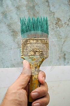 Old paint brush on man hand