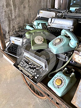 Close-up of old telephones and typewriters photo