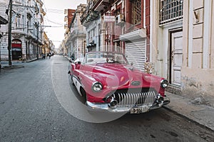 Close-up of old pink Chevrolet parked on Havana street. American classic cars typical of Cuba.