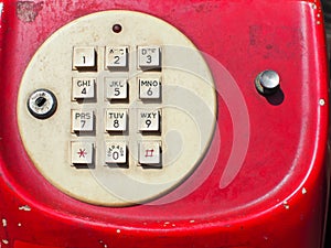 Close up of old retro red phone keypad. Analog dial pad of old phone.
