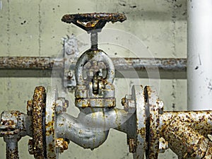 Close-up of an old rusted shut-off valve