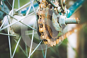 Close up of old rusty chain from the bicycle on background nature ,Bicycle`s detail view of wheel with old chain, sprocket,dirty