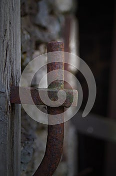An old rusty iron door hinge