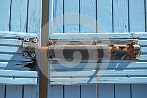 Close up of old rusty lock on blue door