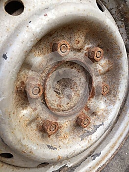 Old rusty metal alloy wheel car