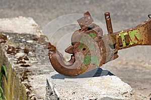 Close up of a old and rusty tractor arrestor hook