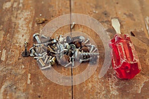 Close-up of an old screwdriver the bolts on the table