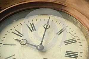 Close-up of an old shabby retro clock, the time is almost midnight. Concept of time, past or deadline