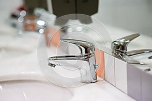 Close up old Stainless steel Chrome tap bathroom and dust on the surface do not clean and sensor for automatic open and