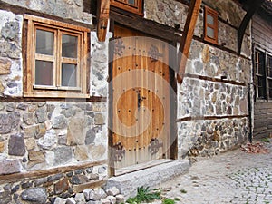 Close up of the old stone house ancient door with metal fittings