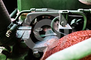 Close-up of an old tractor engine with cooling pipes