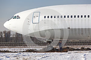 Close up of old unused large passenger plane on a snowy field