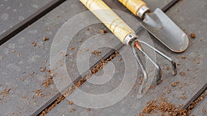 Close up of old used garden tools shovel and rake, top view, selective focus. Spring natural gardening, eco, plant care, organic