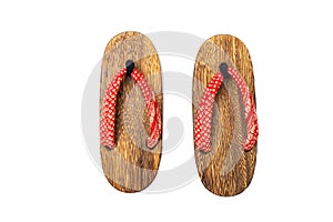 Close up old used wooden Japanese sandal isolated on white background.