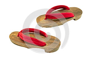 Close up old used wooden Japanese sandal isolated on white background.