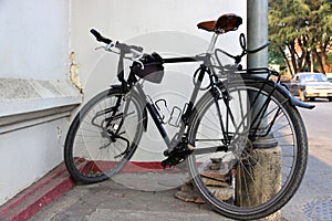 Close-up: An old vintage bicycle parked against the wall
