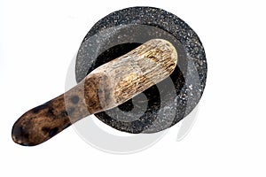 Close up of old vintage mortor and pestle isolated on white till date used in Asian and Indian homes for grinding and crushing spi