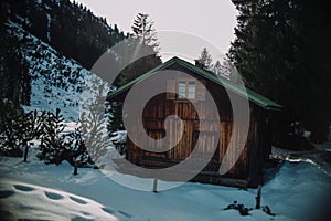 Close up on old vintage mountain house in the snow