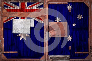 Close-up of old warehouse gate with national flag