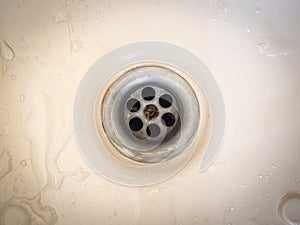 Close up of old water drain of bathtub with stains