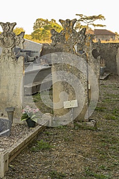 Close-up of an old, weather-worn gravestone in a cemetery